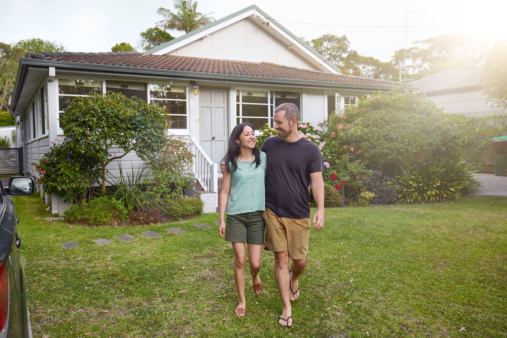 Couple smiling Infront of home